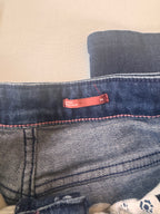 Close-up of a blue denim fabric with a red tag on a beige surface