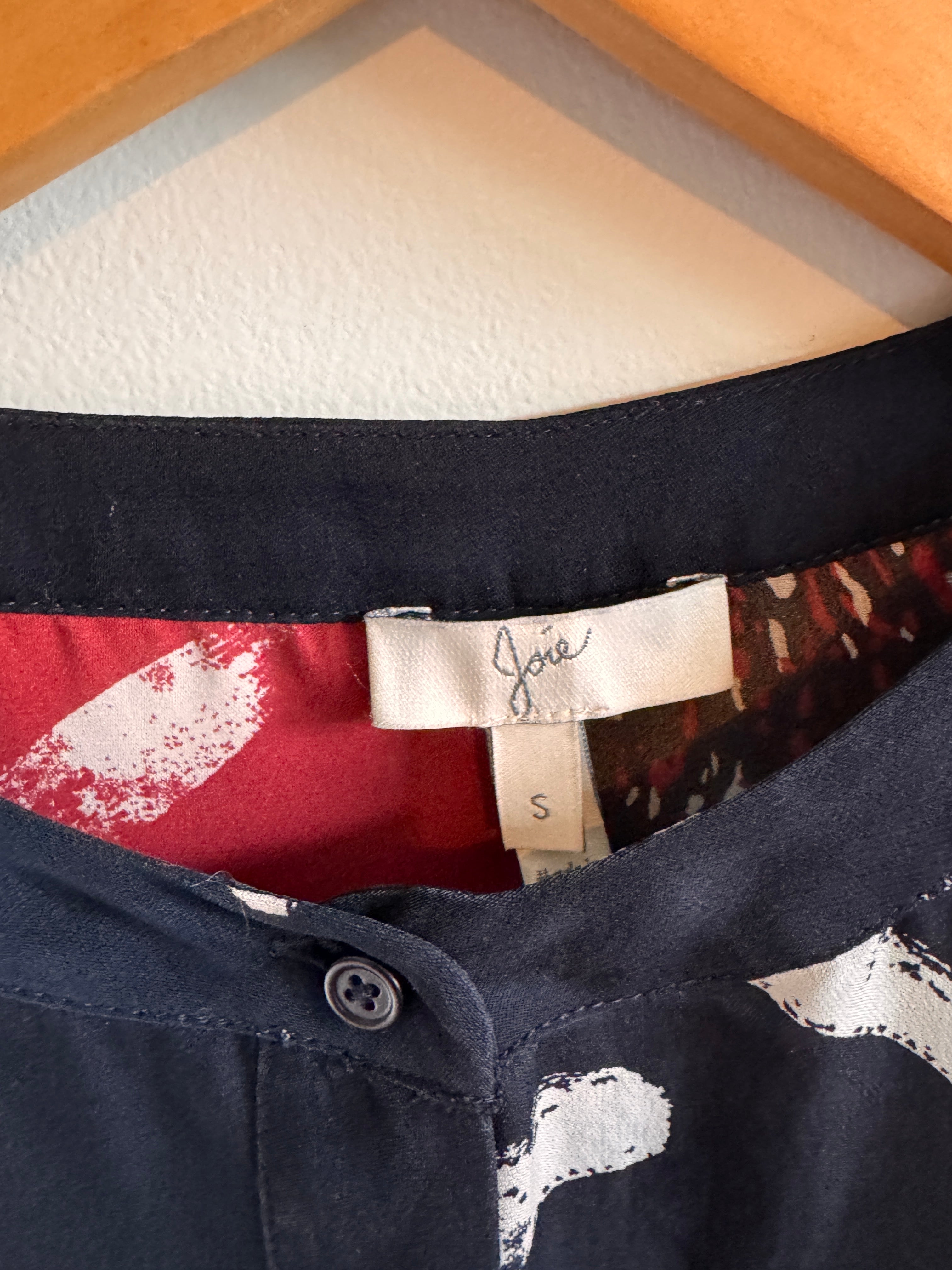 Close-up of a multi-colored shirt with a patterned collar and visible brand label.