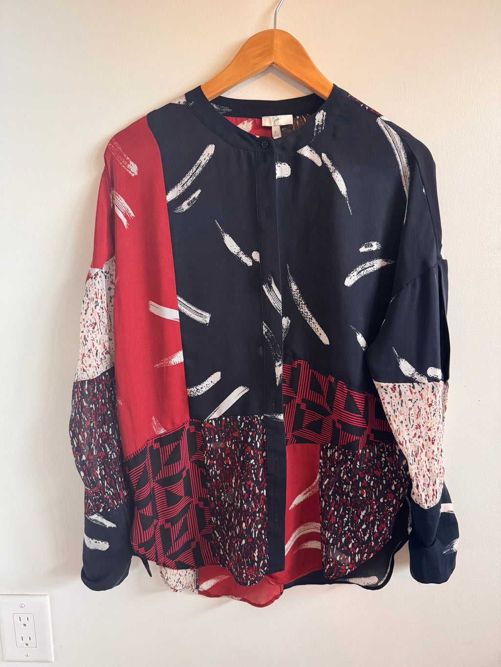 Multi-patterned blouse with geometric patterns on a white background