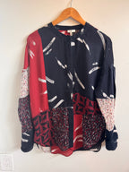 Multi-patterned blouse with geometric patterns on a white background