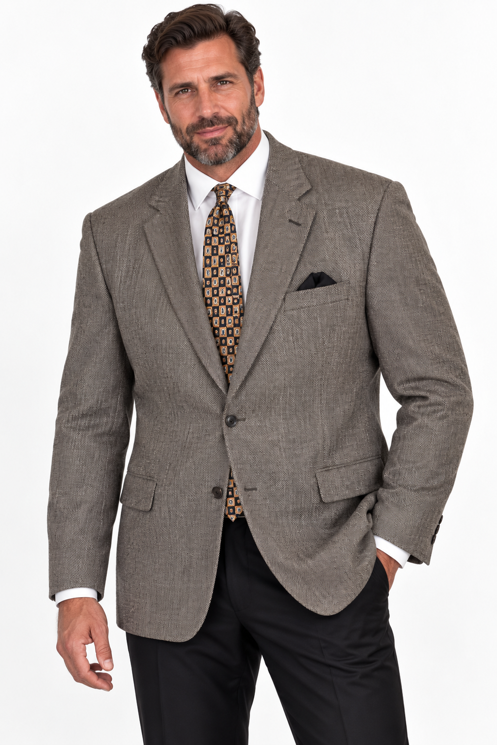 A man wearing a gray textured sport coat, white dress shirt, patterned tie, and black trousers, photographed against a plain white studio background.