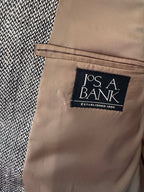 Close-up of a beige interior pocket lining with a black fabric brand label reading 'J.P.