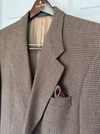 A close-up of a brown and beige micro-patterned blazer jacket hanging on a Nordström hanger, featuring a matching pocket square in the chest pocket.