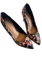Pair of floral-patterned shoes on a light background
