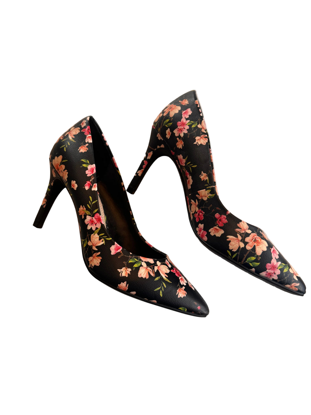 Black high-heeled shoes with floral pattern on a light background