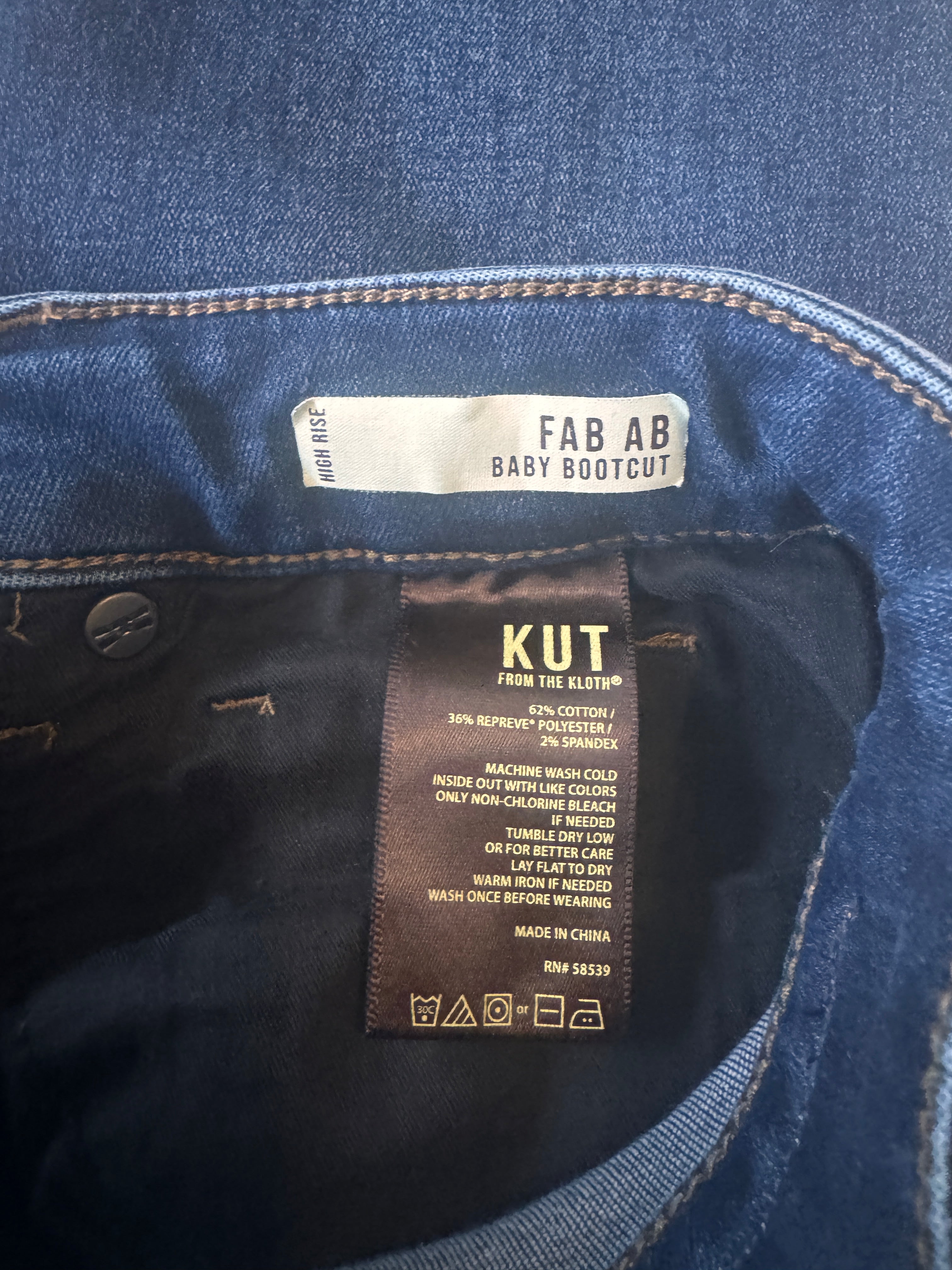 Close-up of denim fabric with brand labels on a dark background