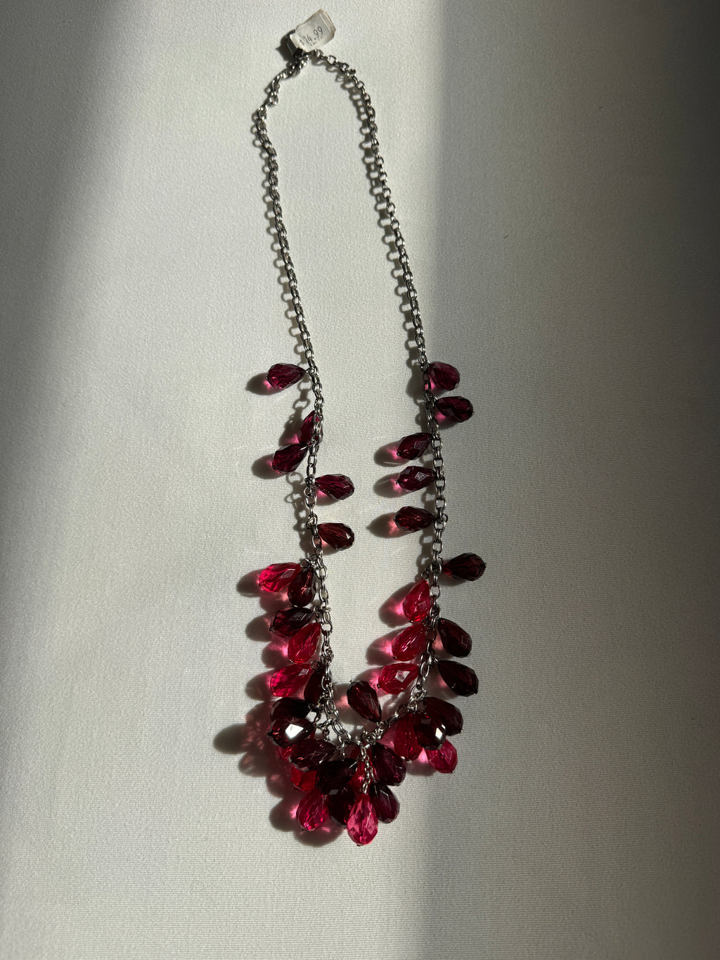 Necklace with red gemstones on a light gray background