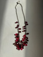Necklace with red gemstones on a light gray background