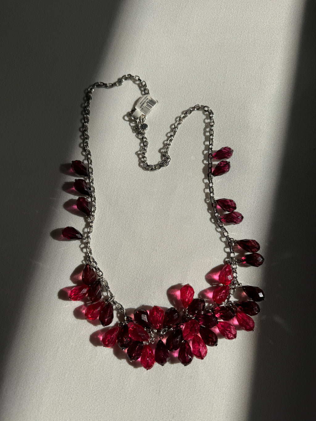 Necklace with red and purple beads on a light background