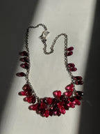 Necklace with red and purple beads on a light background
