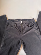 Dark gray pants with brand label on a light background