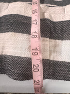 Fabric with a measuring tape showing measurements on a striped background