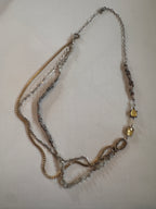 Necklace with multiple chains and beads on a light background