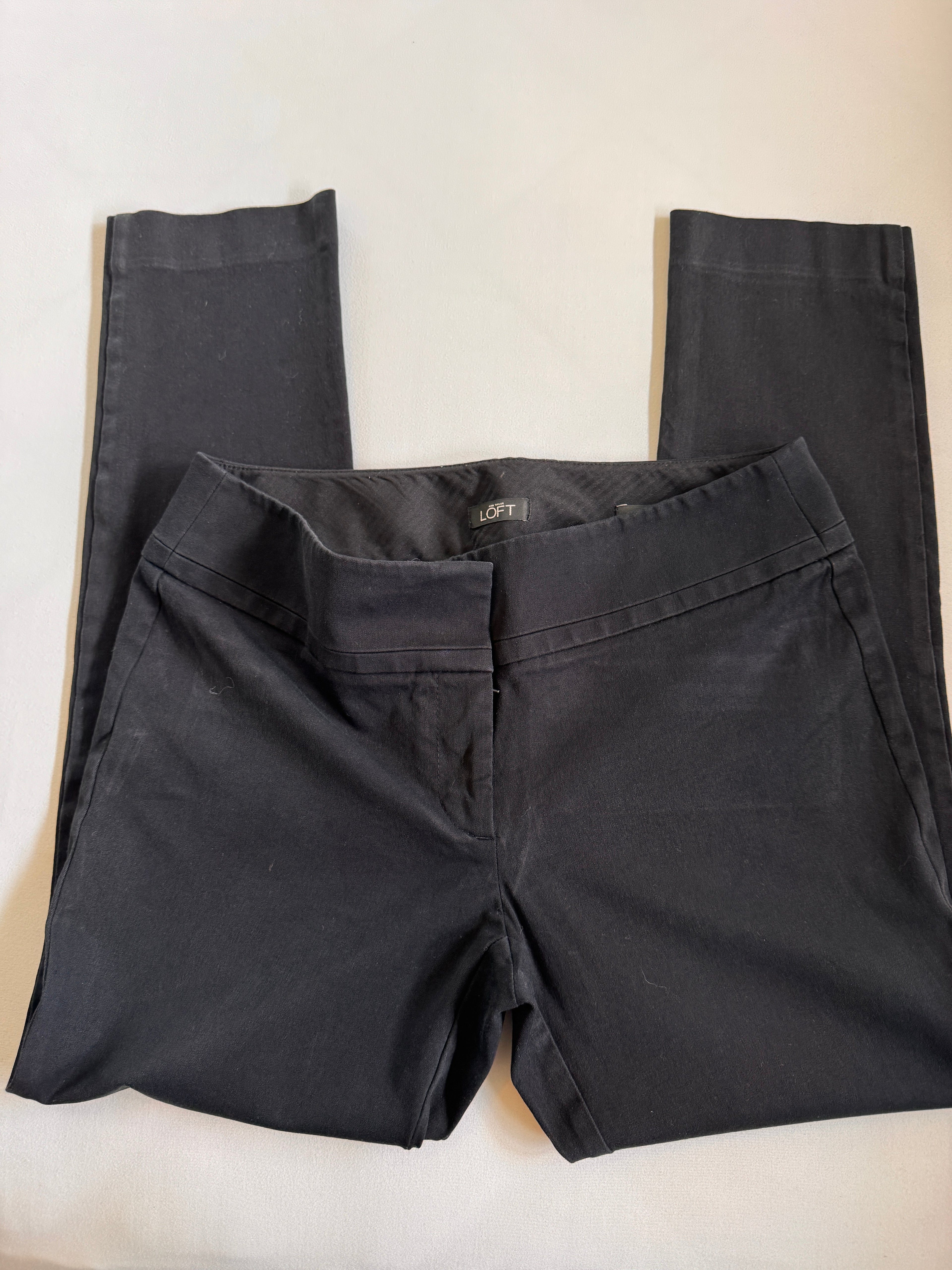 Black pants laid flat on a white surface