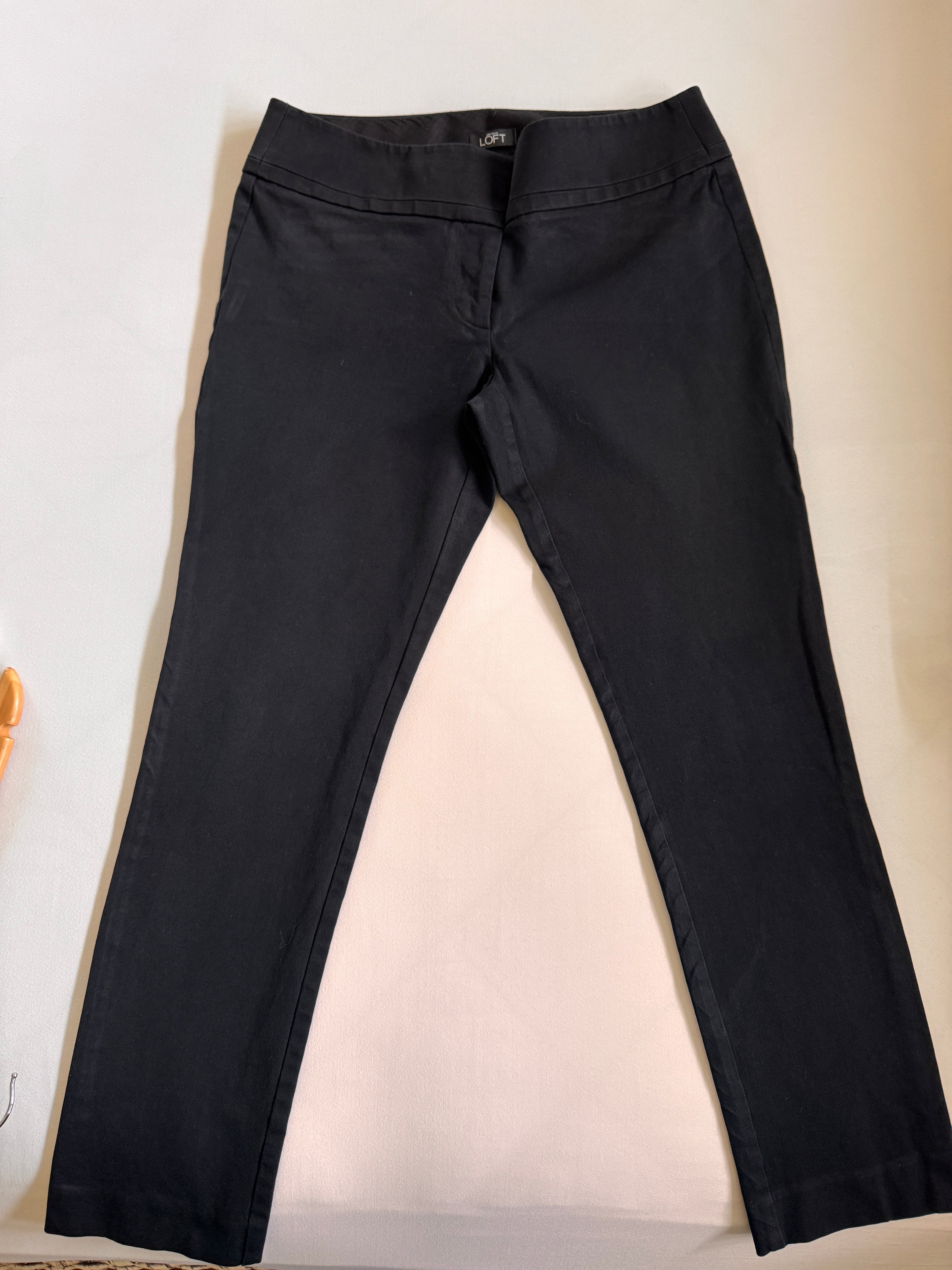 Black pants on a light beige background