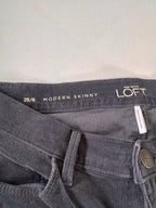 Gray jeans with 'Loft' branding and size information on a light gray background