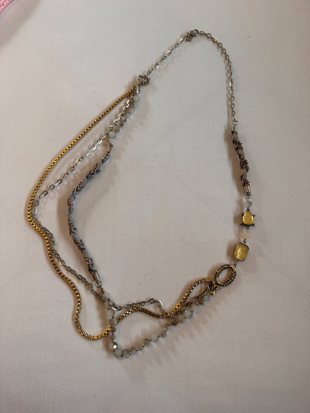 Necklace with beads and chain on a light background