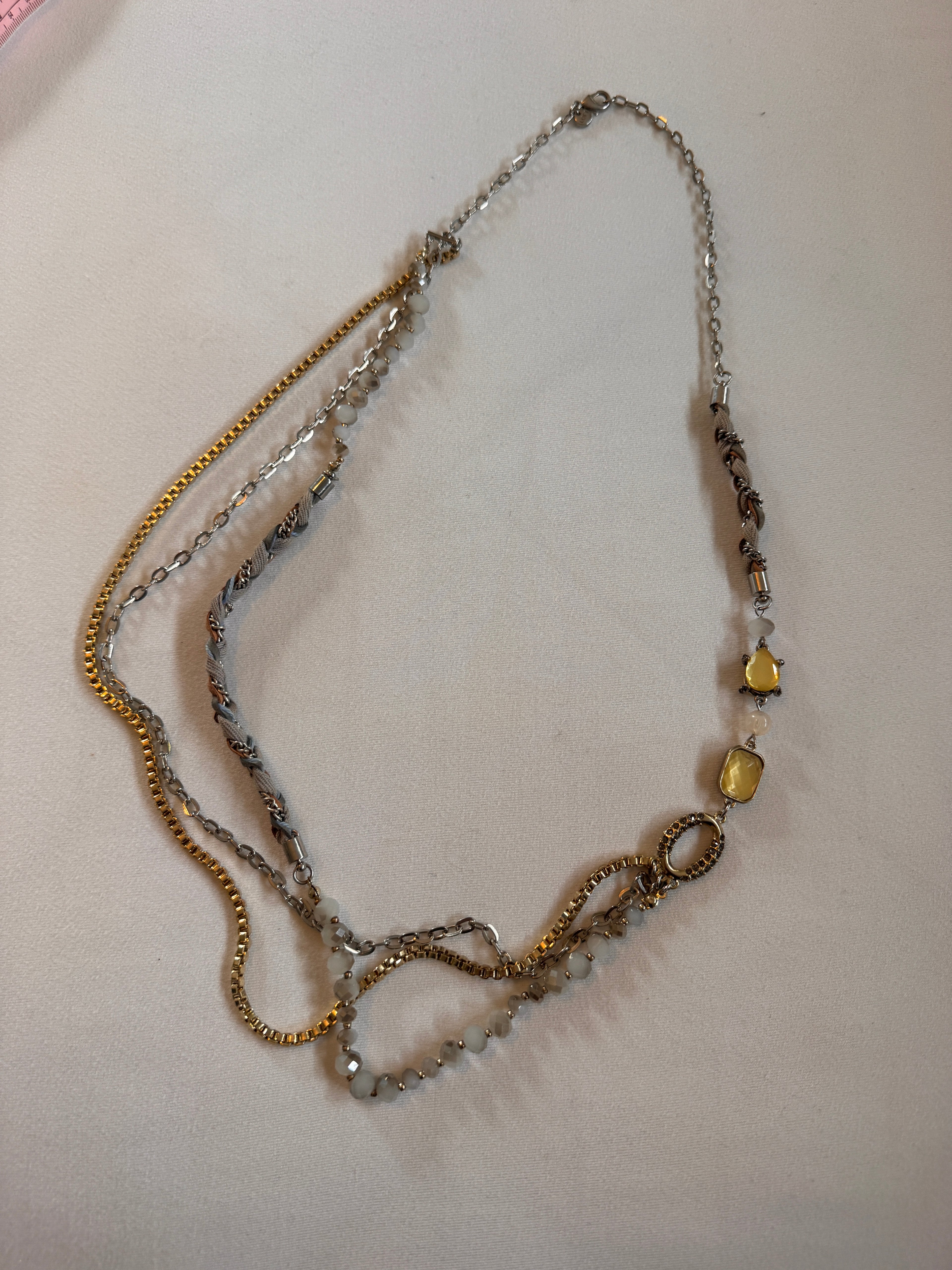 Necklace with beads and chain on a light background