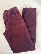 Folded maroon pants on a white background