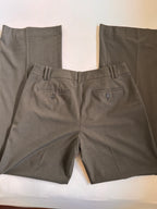 Folded dark gray pants on a white surface