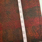 Textured fabric with a ruler for scale on a white background