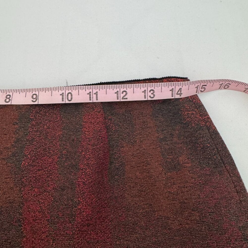 Brown fabric with a pink measuring tape on a white background
