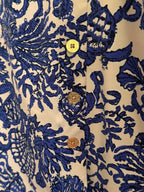 Close-up of a blue and cream patterned garment with a dark navy inner lining, showing the fabric texture and stitching.