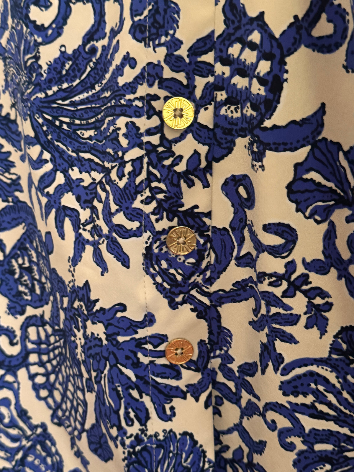 Close-up of a blue and cream patterned garment with a dark navy inner lining, showing the fabric texture and stitching.