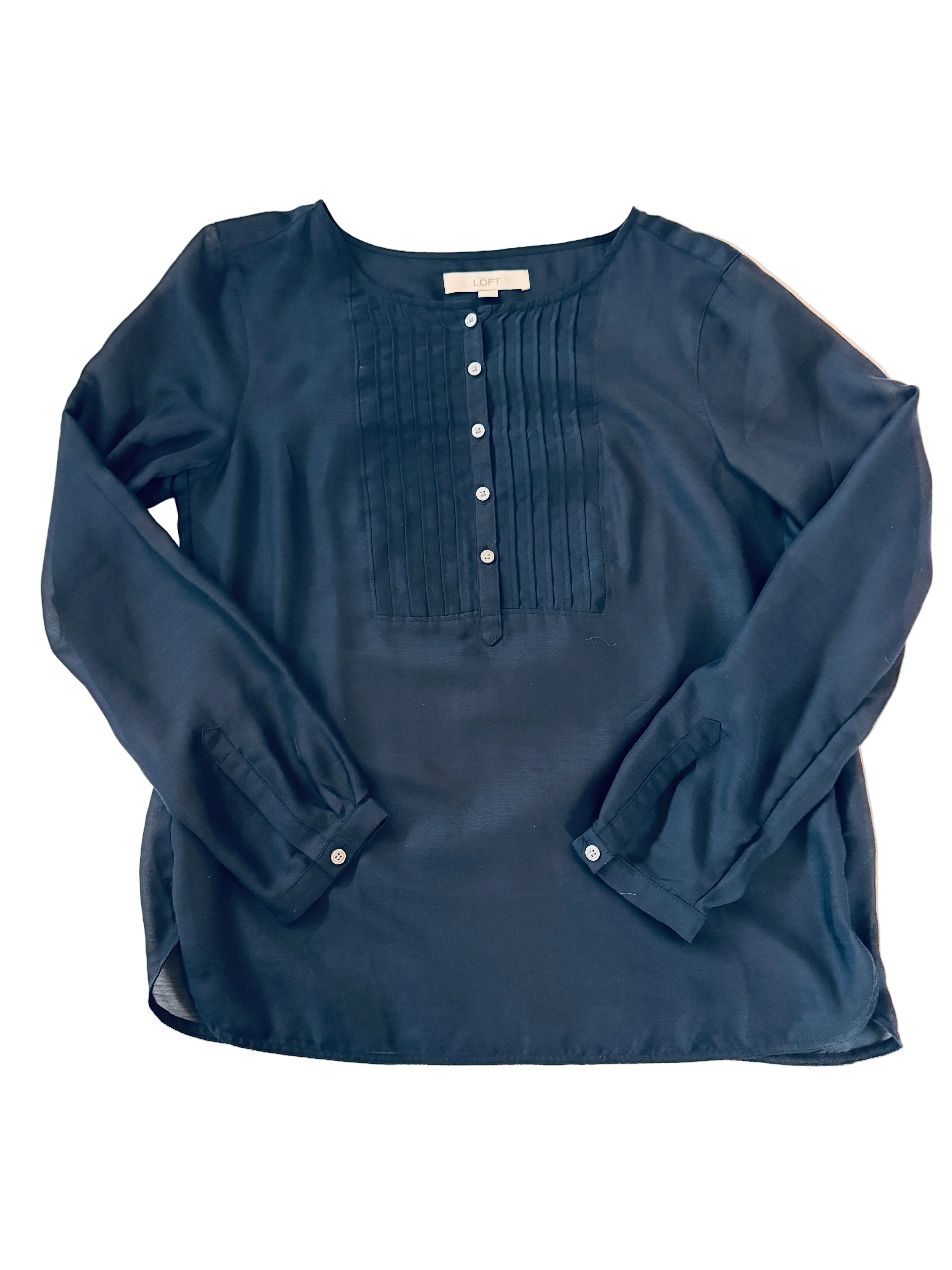 Navy blue shirt with a pocket on a light beige surface