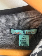 Clothing label with 'Louie Lucie' brand on fabric background
