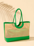 Woven tote bag with green handle and trim on a beige background