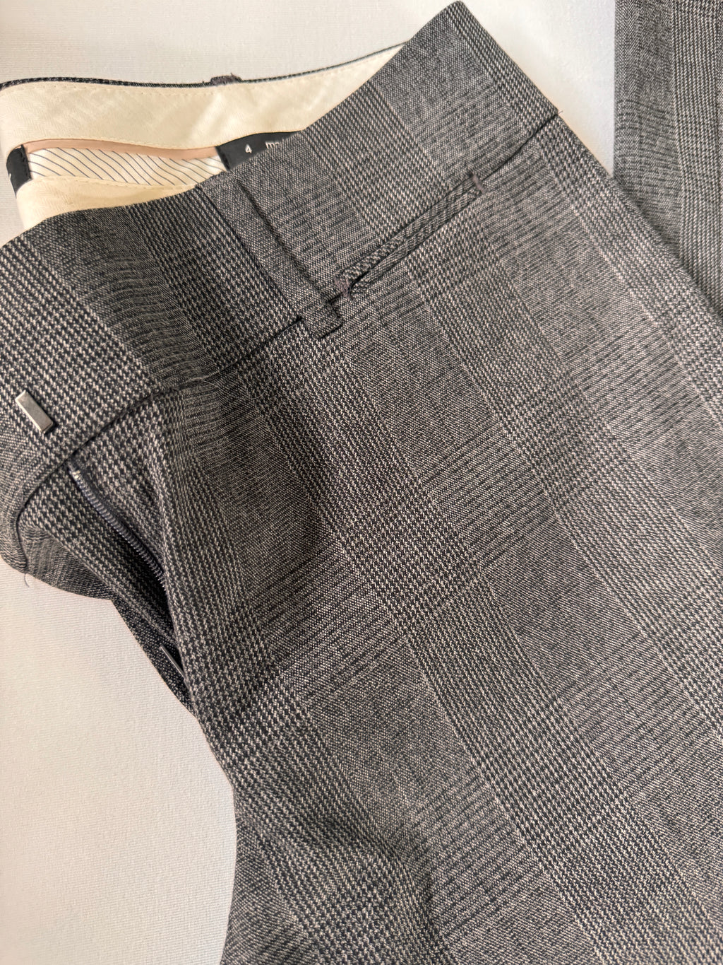 Gray checkered suit pants on a light background