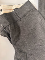 Gray checkered suit pants on a light background