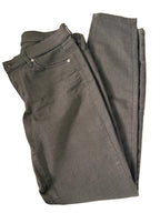 Folded black pants on a beige background