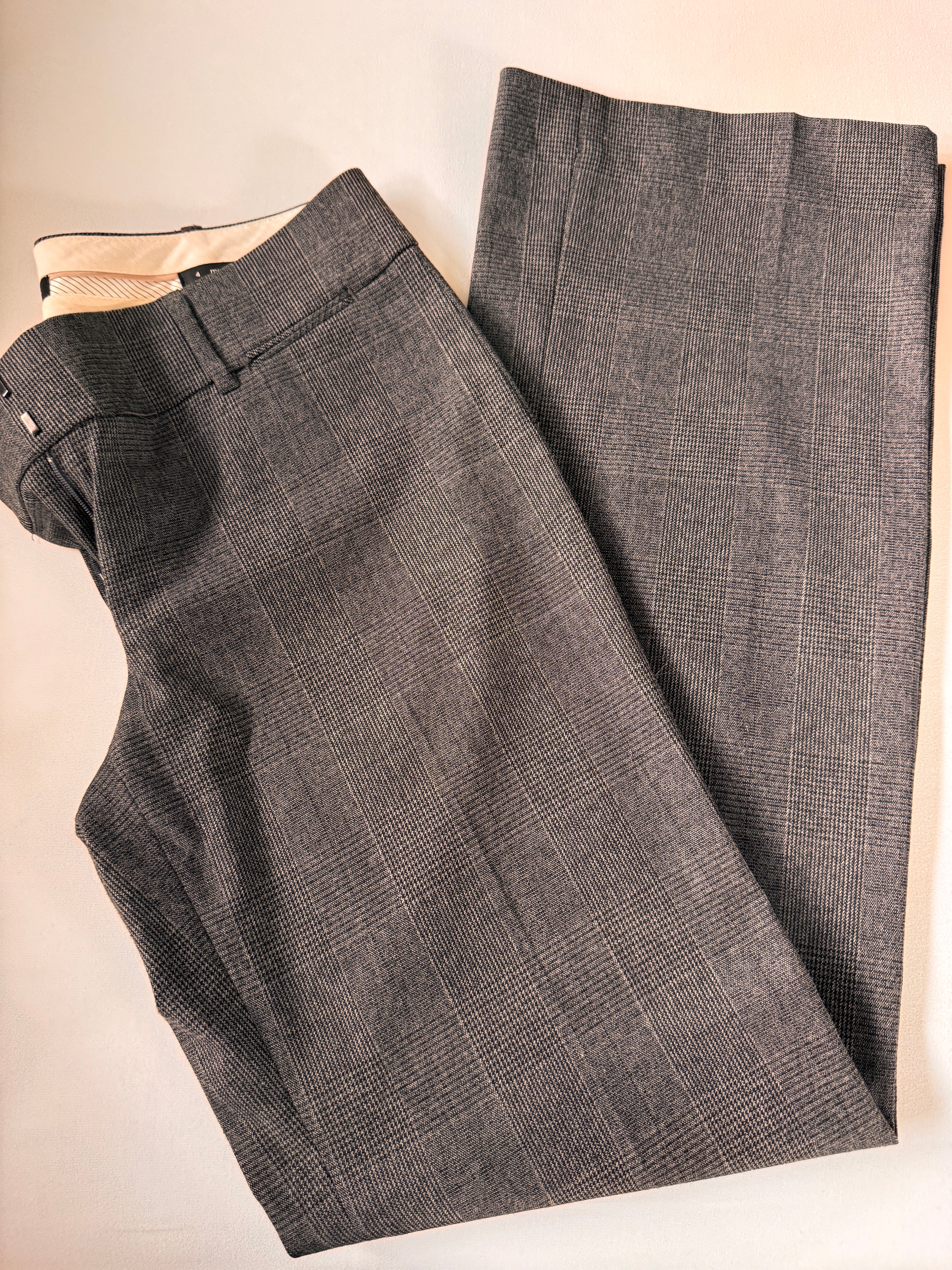 Gray checkered pants on a beige surface