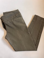 Olive toned pants folded on a light background