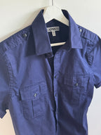 Blue shirt on a white surface with a visible Express tag.