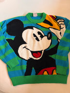 Colorful sweater with cartoon character design on a light background