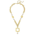 Gold chain necklace with square pendants and pearls on a white background