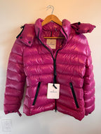 Pink puffer jacket on a hanger against a neutral background