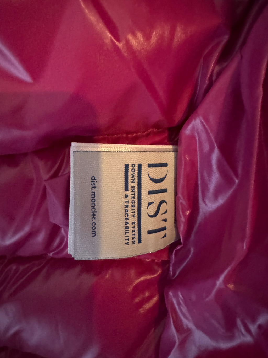 Close-up of a pink jacket with a 'DIST' label on it.