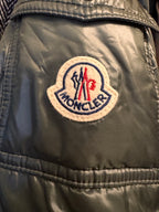 Close-up of a logo patch on a jacket with visible text and colors.