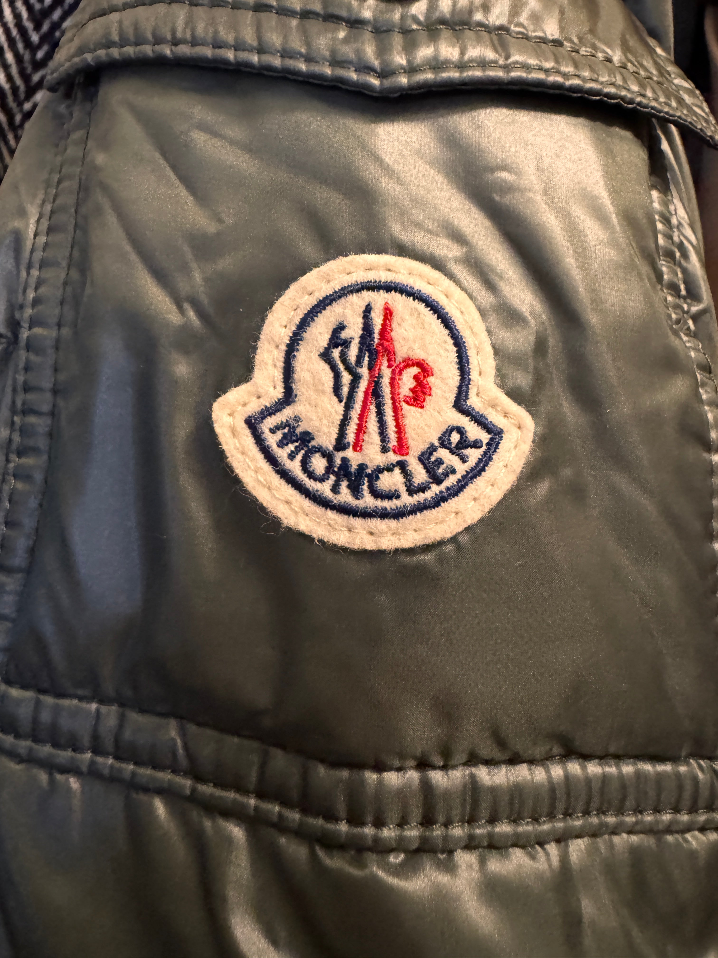 Close-up of a logo patch on a jacket with visible text and colors.