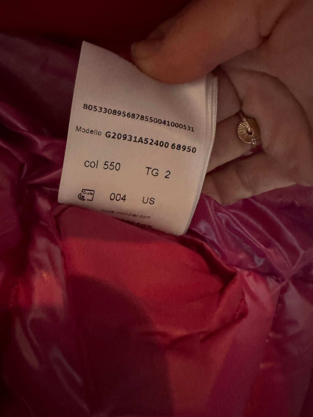 Close-up of a clothing tag on a red garment