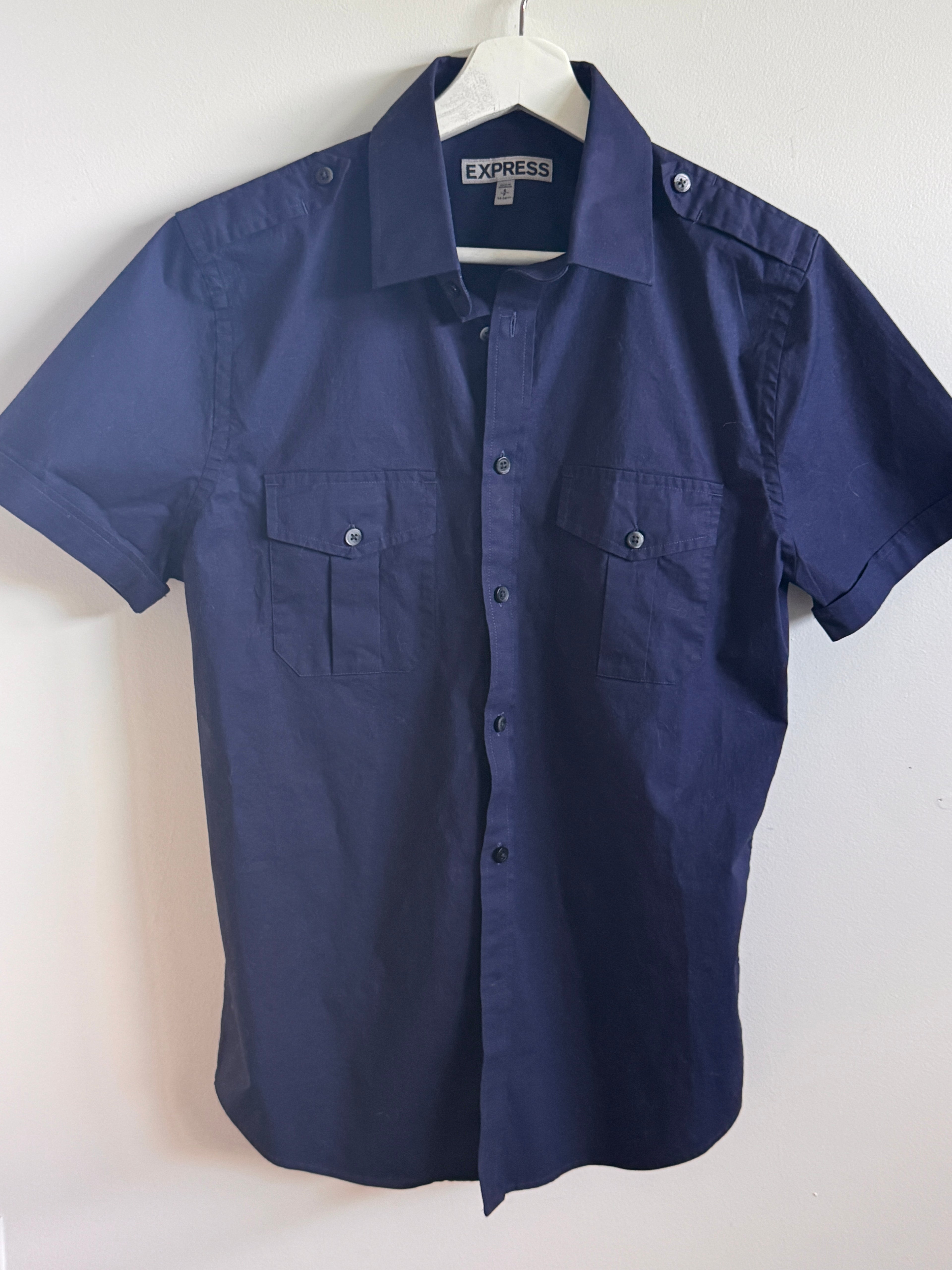Hanging navy blue shirt on a white background