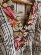 Close-up of floral fabric strip on checkered fabric background