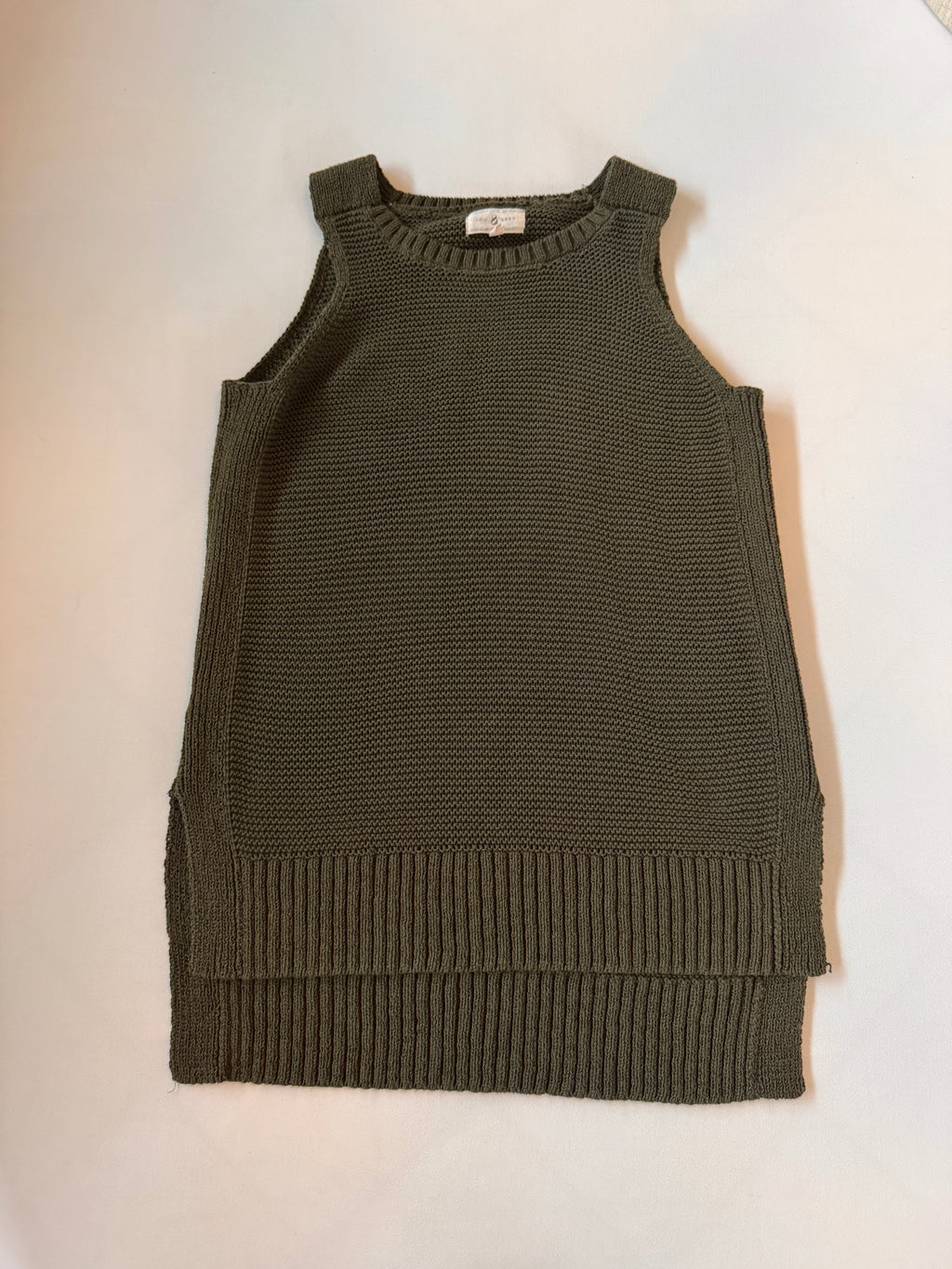 Green knitted sleeveless sweater on a white background