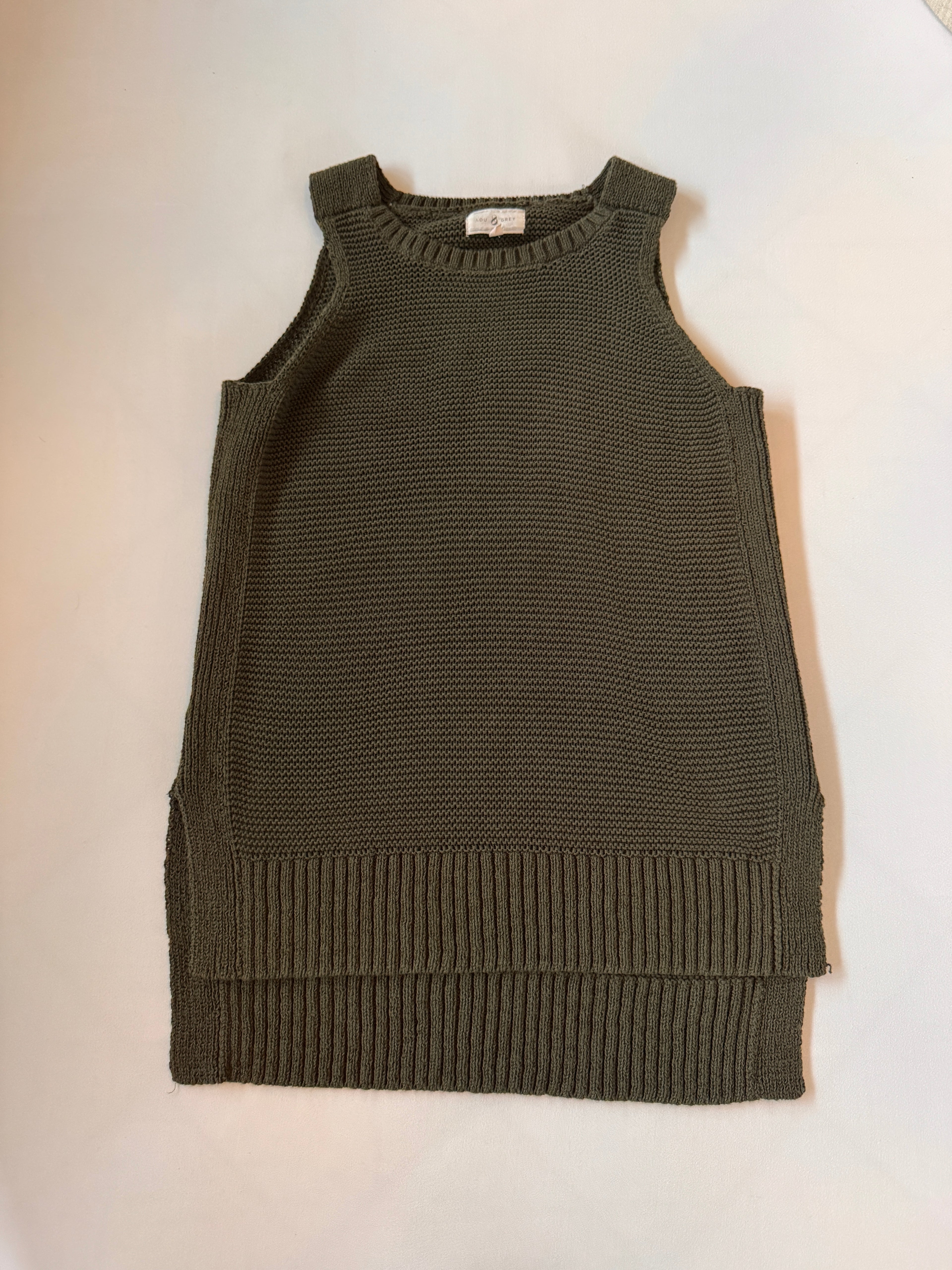 Green knitted sleeveless sweater on a white background