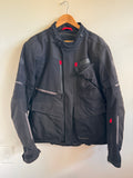 Mens black motorcycle jacket with red accents on white background 