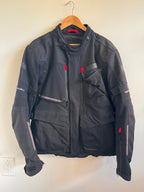 Mens black motorcycle jacket with red accents on white background 